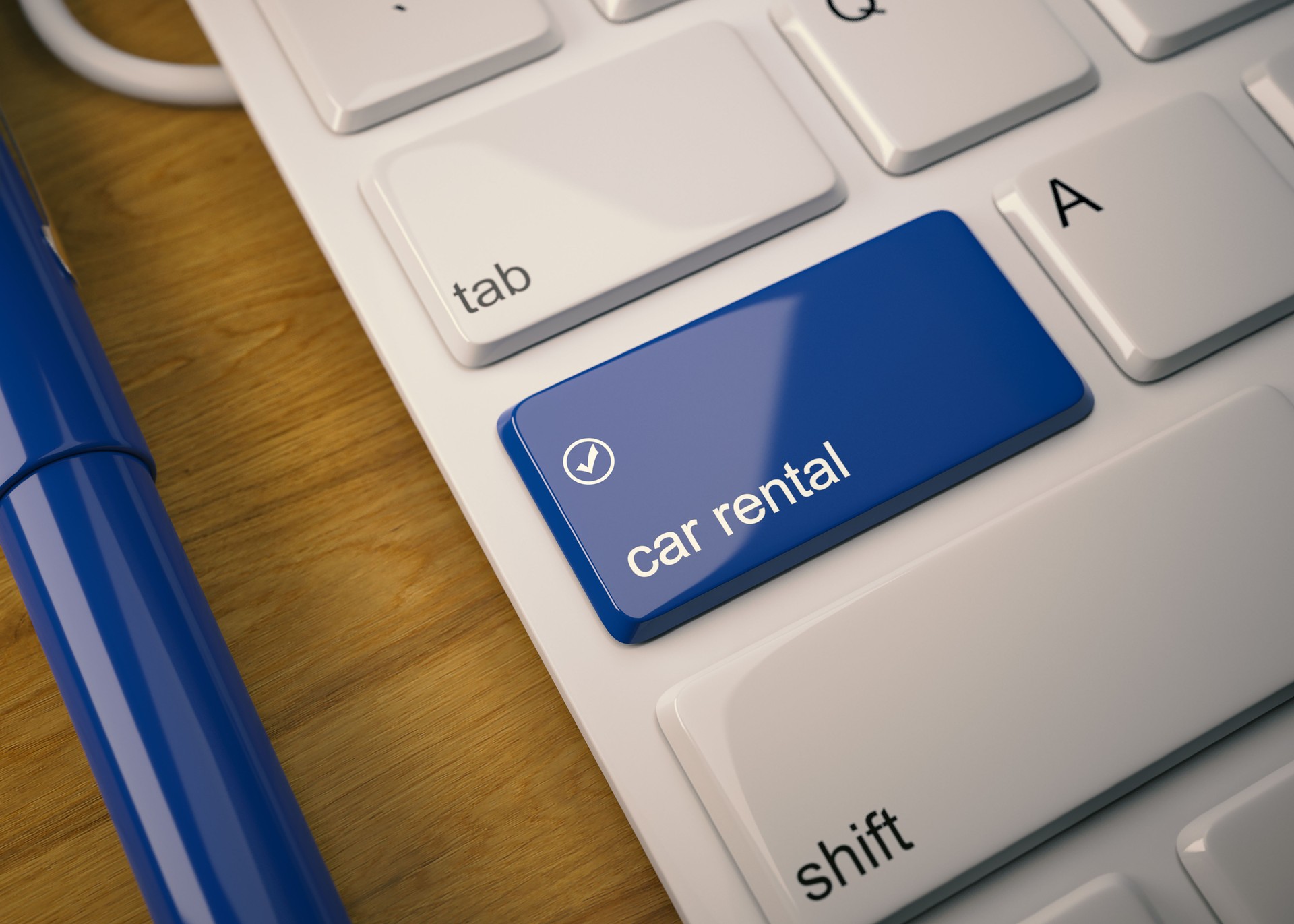 Tastiera bianca con pulsante di noleggio auto su tavolo in legno